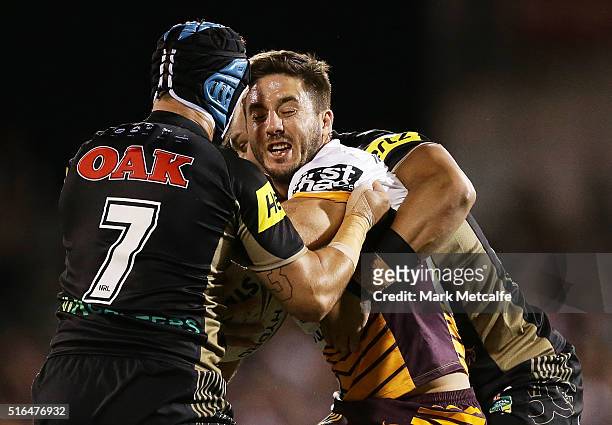 Ben Hunt of the Broncos is tackled by Jamie Soward of the Panthers during the round three NRL match between the Penrith Panthers and the Brisbane...