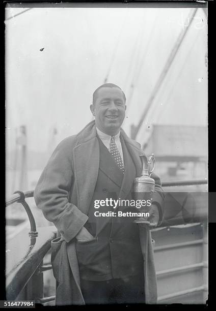 Bringing back the bacon...Pictured above is Walter Hagen, as he returned to the United States at New York aboard the S.S. Leviathan, holding the cup...