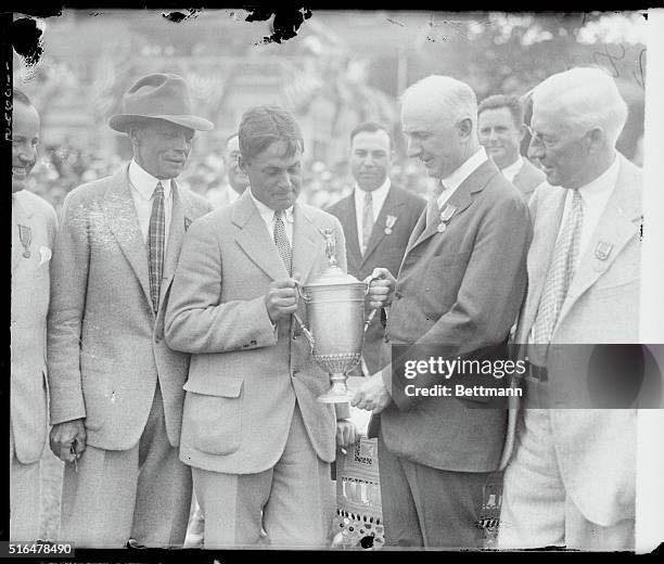 Columbus, Ohio: Photo shows Bobby Jones being presented with the championship cup by U.S. Golf Association President W.C. Fownes, Jr. After Jones won...