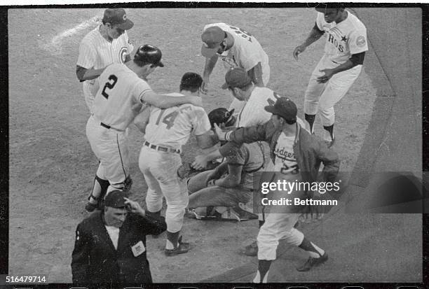 On a single to center hit by Chicago Cubs' Jim Hickman, Cincinnati Reds' Pete Rose scores the winning run in the 12th inning, colliding with...