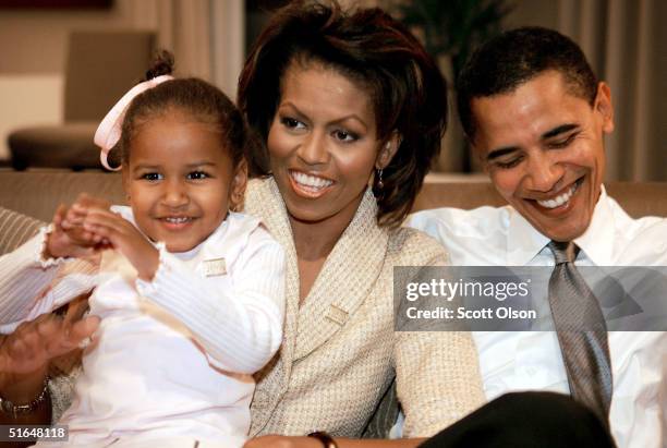 Candidate for the U.S. Senate Barack Obama sits with his wife Michelle and daughters Sasha in a hotel room as they wait for election returns to come...