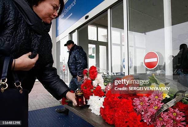 Woman lays flowers at the airport entrance in Rostov-on-Don on March 19, 2016. A flydubai passenger jet crashed in southern Russia early Saturday,...