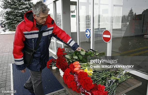 Man lays flowers at the airport entrance in Rostov-on-Don on March 19, 2016. A flydubai passenger jet crashed in southern Russia early Saturday,...