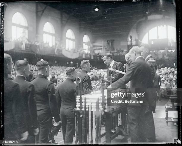 Naval Academy graduates large class...Assistant Secretary of Navy Theodore Roosevelt, handing out their diplomas to the graduating class of 500...