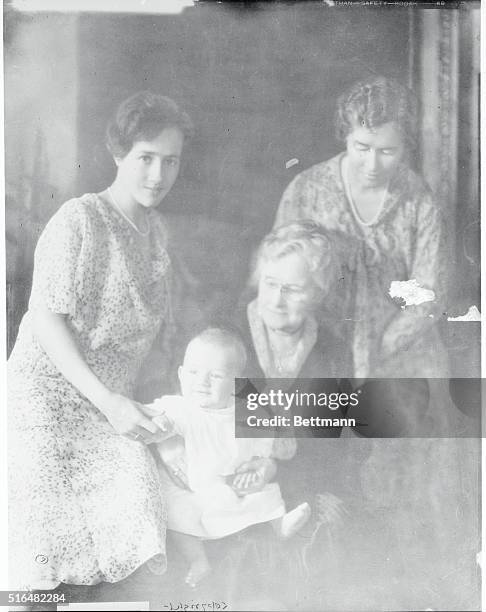 Charles A. Lindbergh, Jr., son of the flier, is shown with his mother, grandmother and great-grandmother. Young Lindy is just seven months old. Right...