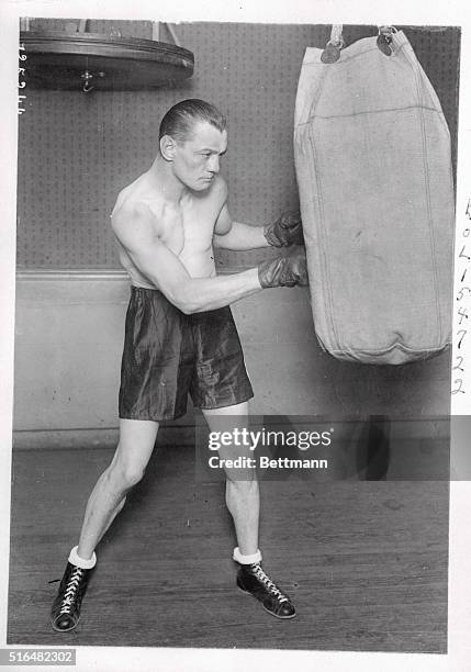 Eugene Criqui, staging another "come back" against Young Humerg. Photo shows Criqui working with punching bag.