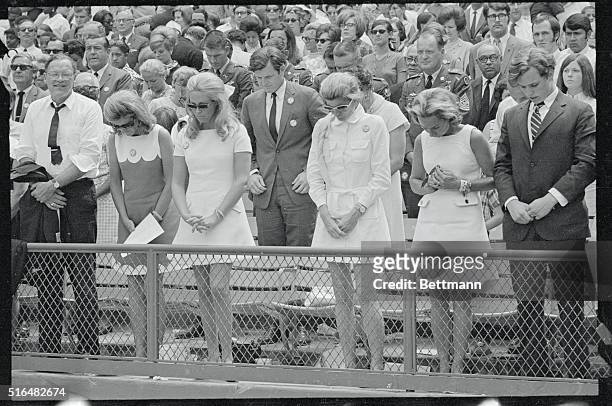 Members of the Kennedy family bow their heads during a ceremony at which the former District of Columbia Stadium in Washington is dedicated as the...