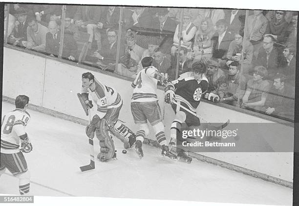 Boston: Bruins-Rangers-NHL Playoffs. Rangers' goalie Terry Sawchuk retreats to his net as teammate Arnie Brown comes in to battle Bruins' Derek...