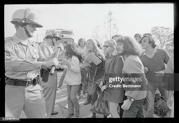 Riverside police hold back University of California students during the height of a demonstration marking the first reelection visit of California...