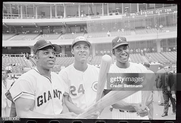 Big men in the National League do their thing for photographers here prior to the All Star Game. They are , Willie Mays, of the San Francisco Giants,...