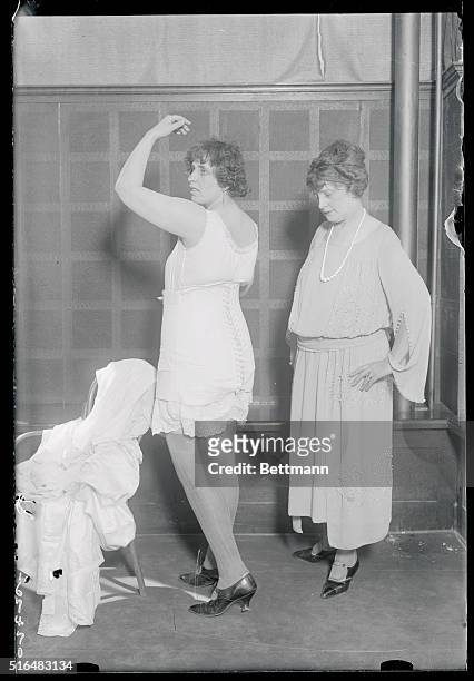 Models rehearse fashion pagenat for masonic show. Miss Eva Hegarman, wearing a corset that is reputed to have the qualities of making a 250 pound...