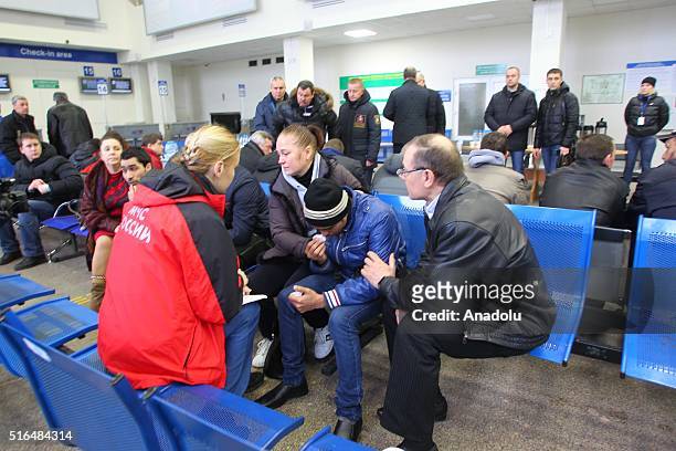 An Emergency psychologist comforts a relative of passengers after FlyDubai Boeing 737-800 crashed down on the runway at the Rostov on Don airport in...