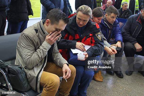 An Emergency psychologist comforts a relative of passengers after FlyDubai Boeing 737-800 crashed down on the runway at the Rostov on Don airport in...