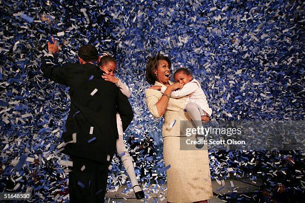 Candidate for the U.S. Senate Barack Obama holding his daughter Malia with wife Michelle and youngest daughter Sasha celebrate his victory with...