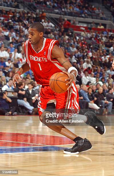 Tracy McGrady of the Houston Rockets drives against the Detroit Pistons on November 2, 2004 at the Palace of Auburn Hills in Auburn Hills, Michigan....