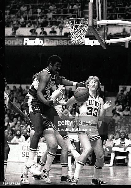 Paul Silas the Sonics leaps for a rebound as Celtics' Larry Bird watches during 2nd quarter action of game at Boston Garden, 1/20. Seattle won in...