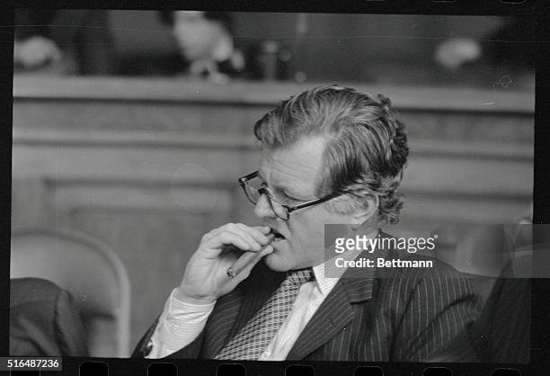 Washington: Sen. Edward Kennedy, D-Mass., chews on a cigar at a hearing of his Senate Judiciary Committee as short while after a woman entered his...