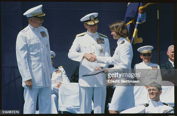 Annapolis, Maryland: Midshipman Elizabeth Belzer with diploma and becomes first woman ever to graduate from the United States Naval Academy.