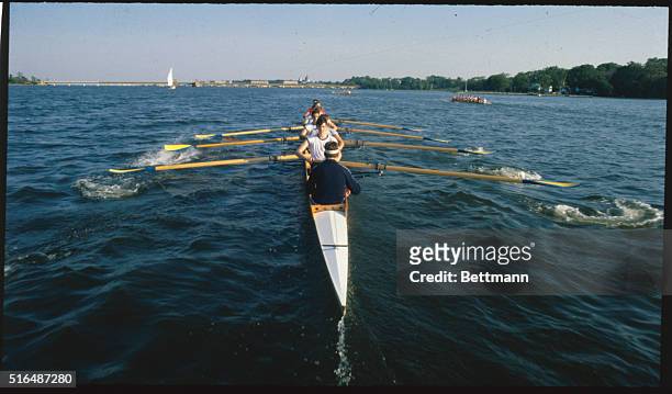 Annapolis, Maryland: Eight man shells of the United States Naval Academy's heavyweight crew team slip quickly and quietly down the Severn River.