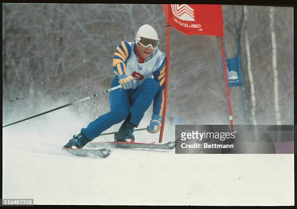 Lake Placid, New York: Olympic giant slalom gold medalist Ingemar Stenmark shoulders a gate, as he drives to a come-from-behind victory 2/19....