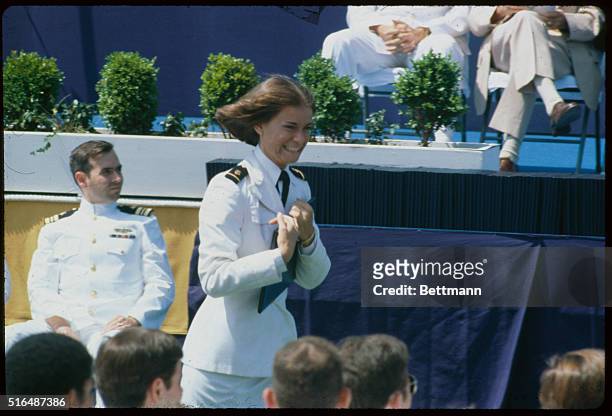 Annapolis, Maryland: Midshipman Elizabeth Belzer with diploma and becomes first woman ever to graduate from the United States Naval Academy.