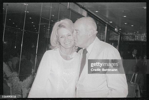 New York, New York: Actress Angie Dickinson is kissed by her father-in-law, Burt Bacharach, Sr., at a party here celebrating opening of her new film,...