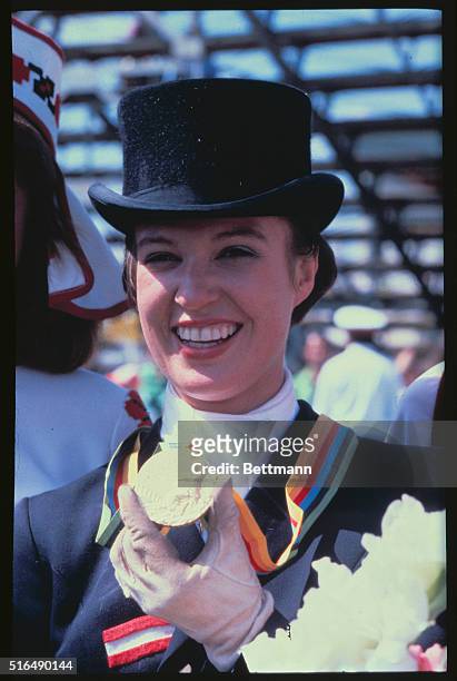 Elisabeth Theurer of Austria displaying her Equestrian Olympic gold medal, won in the dressage grand prix, individual class.