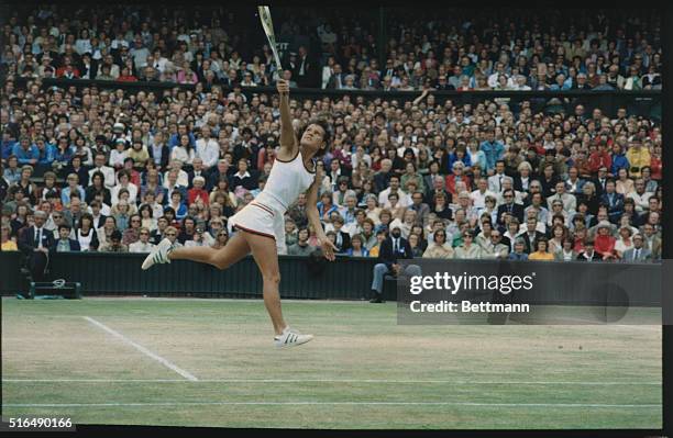 Wimbledon, London, England: Evonne Cawley holds aloft her trophy here, July 4, after defeating Chris Evert Lloyd in the Ladies' Singles Final, 6-1,...