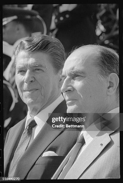 Washington, D.C.: President Reagan with French president Francois Mitterrand as they leave White House after their meeting.