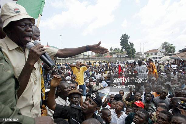 Nigerian police officer Dan Adegbuyi tries to stop President of the Nigerian Labour Congress, Adams Oshiomhole from addressing a crowd 03 November,...