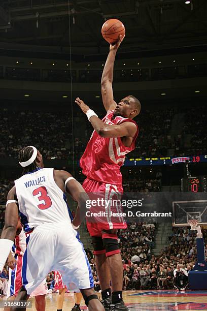 Dikembe Mutombo of the Houston Rockets shoots against Ben Wallace of the Detroit Pistons on November 2, 2004 at the Palace at Auburn Hills in...