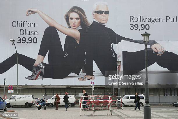Cyclist passes a giant 1,500 square meter advertisement for Swedish fashion retailer H&M that shows German-born fashion designer Karl Lagerfeld and...