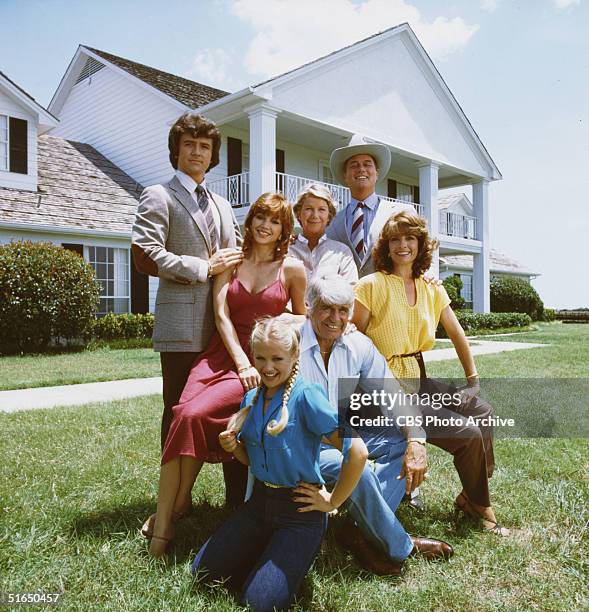Promotional still from the American television series 'Dallas' shows members of the Ewing family as they pose in front of their television home, the...