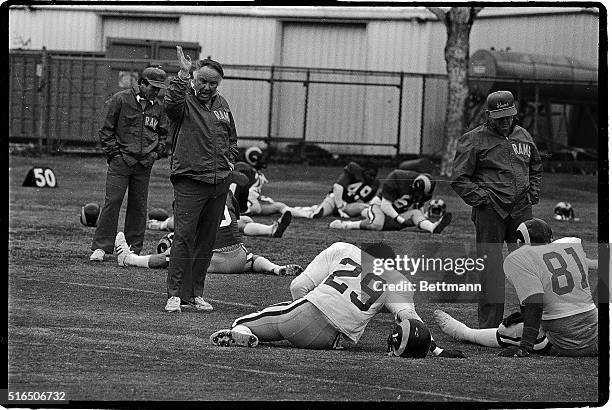 Los Angeles Rams coach John Robinson encourages running back Eric Dickerson during a workout at practice 12/19. The Rams will meet the New York...