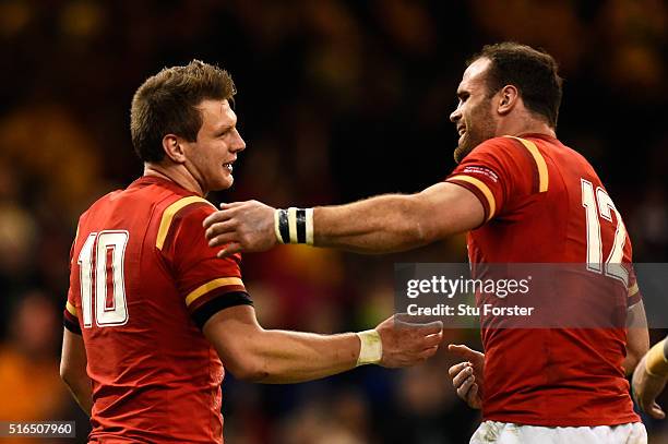 Dan Biggar of Wales is congratulated by teammate Jamie Roberts after scoring his team's second try during the RBS Six Nations match between Wales and...