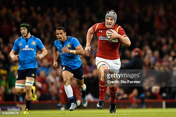 Jonathan Davies of Wales sprints clear to score his team's third try during the RBS Six Nations match between Wales and Italy at the Principality...