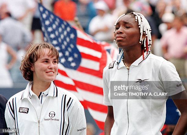Martina Hingis of Switzerland stands with Venus Williams of the US 07 September after their women's final match at the US Open in Flushing Meadows,...