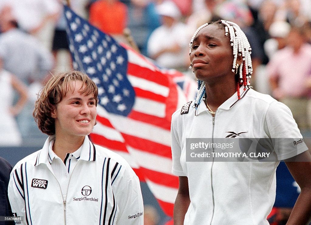 Martina Hingis of Switzerland (L) stands with Venu