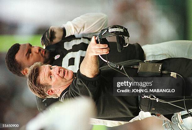 Oakland Raiders head coach Joe Bugel questions a penalty called against the Raiders as defensive end Chester McGlockton listens 08 September during...