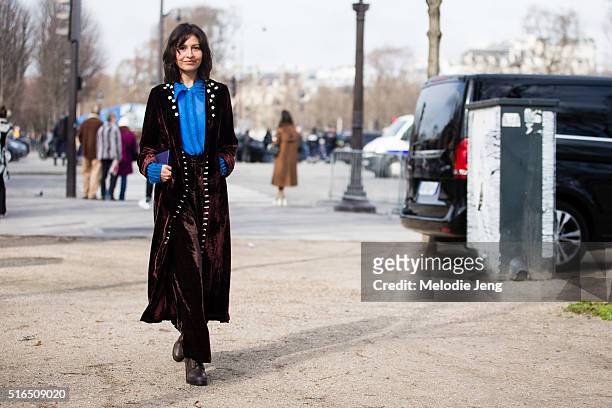 Wara Juana Gutierrez Mamani, Jupe by Jackie designer, wears an auburn color silk pajama-style outfit with a detailed blue top after the Chanel show...