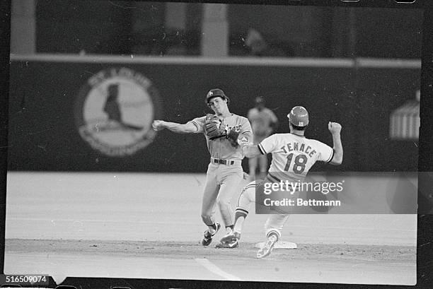 St. Louis: Los Angeles Dodgers' Steve Sax is forced to make a leaping throw over sliding St. Louis Cardinals' Gene Tenace to allow David Green to...