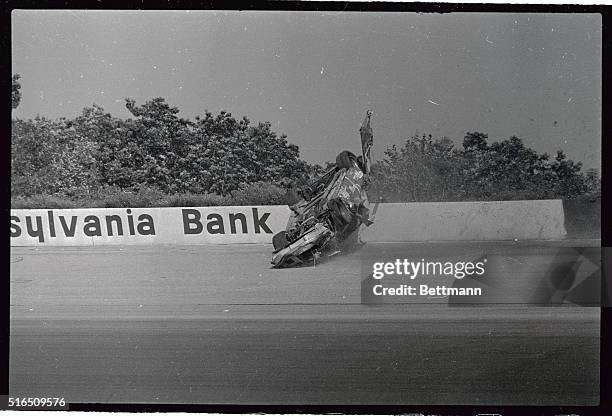 Dale Earnhardt's car rides the wall here before coming to rest on his roof after he lost his brakes going into the first turn and hit Tim Richmond...