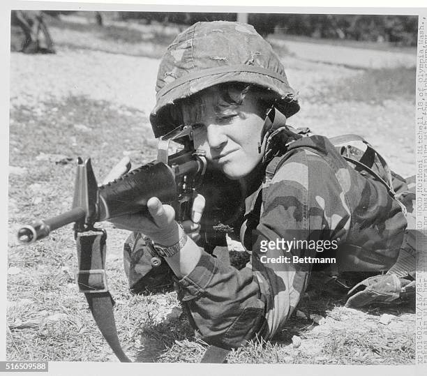 Moni Mitchell of Olympia, Washington takes aim with her rifle during basic training with the alpha company, 5th battalion 3rd brigade at Fort Leonard...