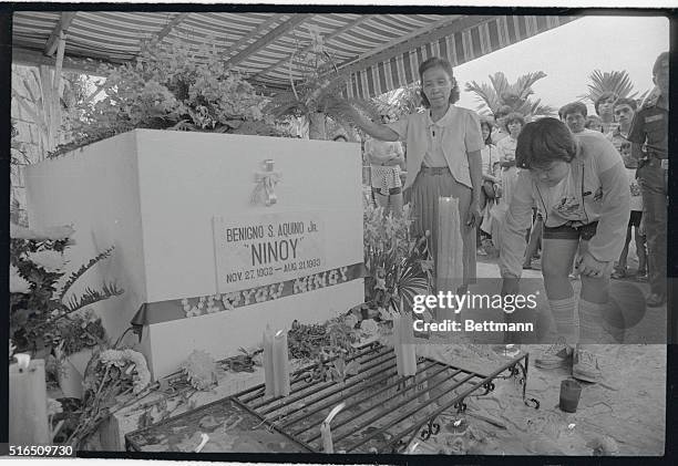 The children of slain opposition leader Benigno Acquino, Benigno "Noynoy" Acquino Jr. And Kris visit the grave of their father during the observance...