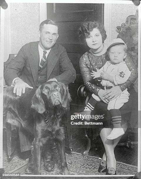 Rogers Hornsby, manager of the St. Louis National baseball team, Mrs. Hornsby, young William and the family pet and mascot, spend a quiet evening at...