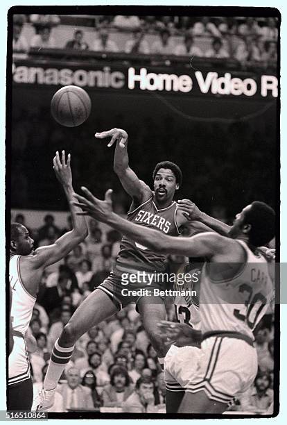 Julius Erving is forced to pass off as he is surrounded by Celtics players during the first quarter action of game 5, Eastern Conference Finals at...