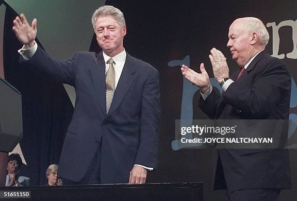 President Bill Clinton, , waves after addressing the AFL-CIO Convention 24 September in Pittsburgh, PA as AFL-CIO President John Sweeney applauds....