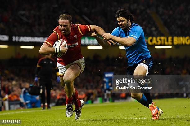 Jamie Roberts of Wales hands off Luke McLean of Italy to score his team's fourth try during the RBS Six Nations match between Wales and Italy at the...