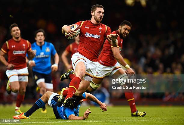 George North of Wales evades the tackle from Luke McLean of Italy to run in his team's fifth try during the RBS Six Nations match between Wales and...