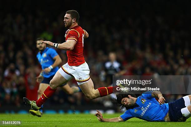 George North of Wales evades the tackle from Luke McLean of Italy to run in his team's fifth try during the RBS Six Nations match between Wales and...